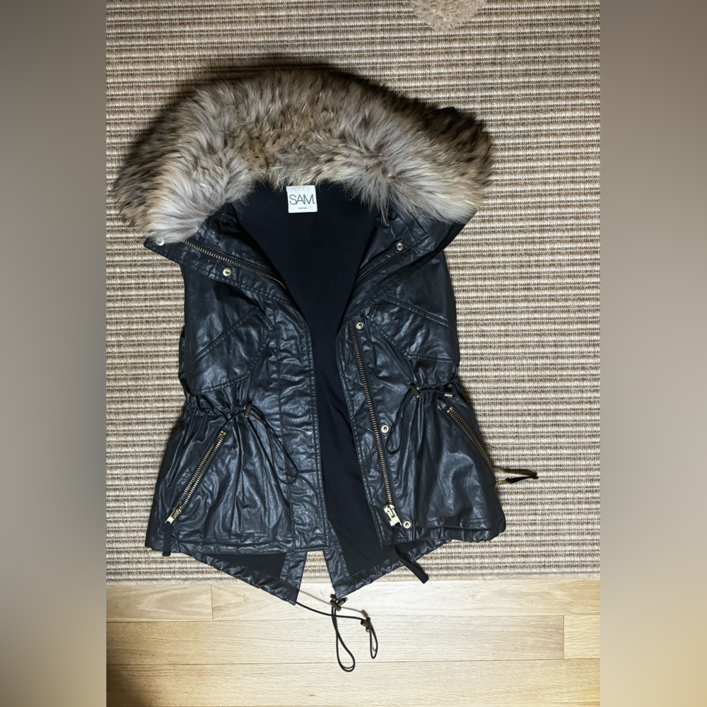 Sam Dekota black with fur vest.